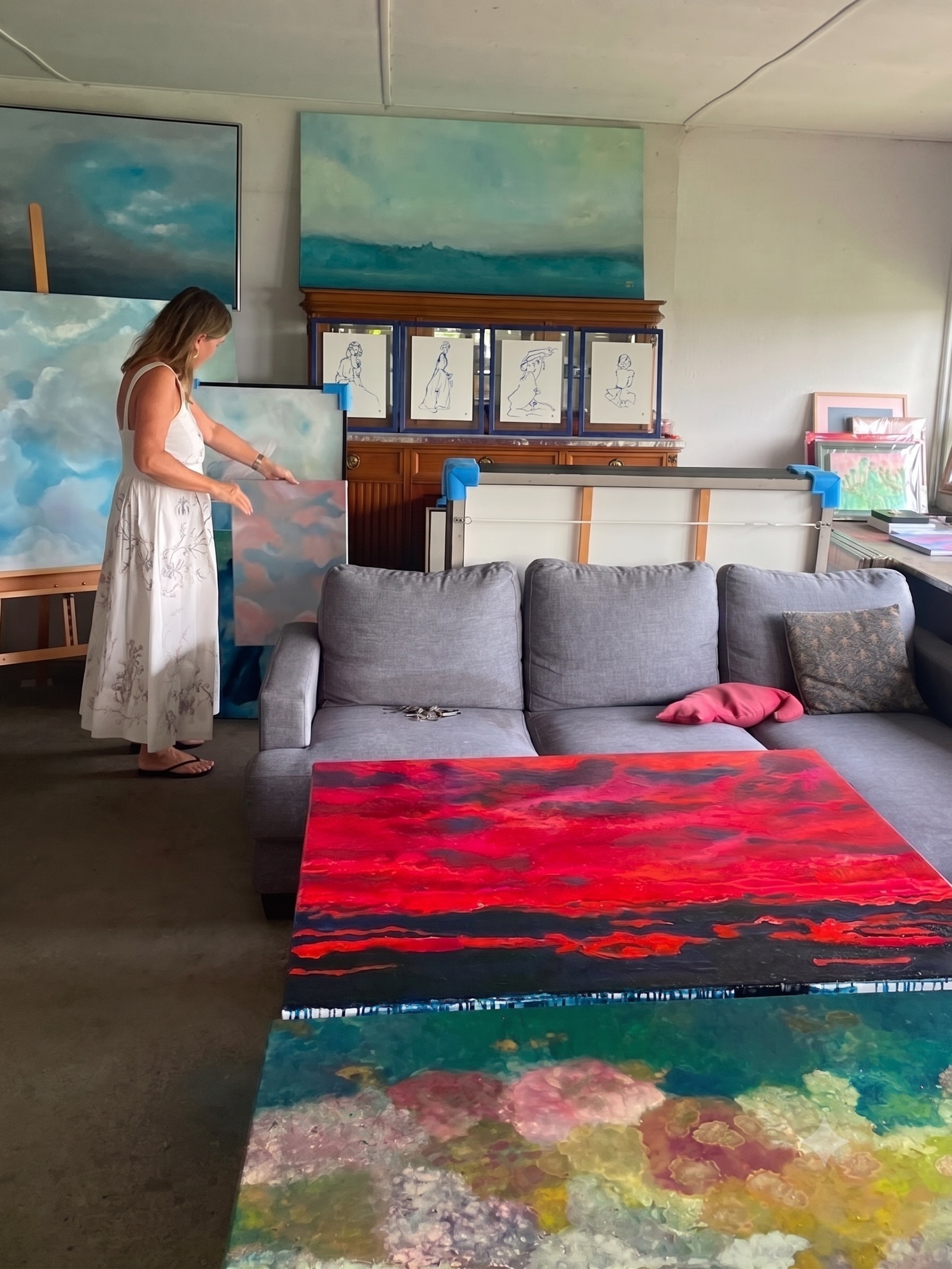 Isabelle Étienne in her studio, arranging her paintings
